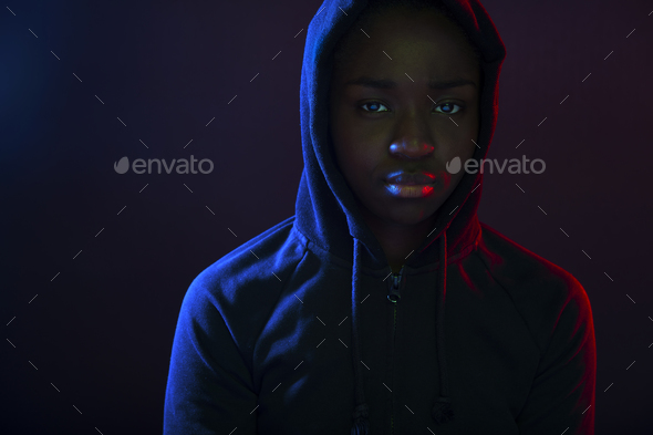 Colorful portrait of a cool woman with dark skin wearing hoodie - Stock Photo - Images