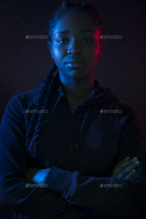 Dark colorful portrait of confident african woman with dark skin - Stock Photo - Images