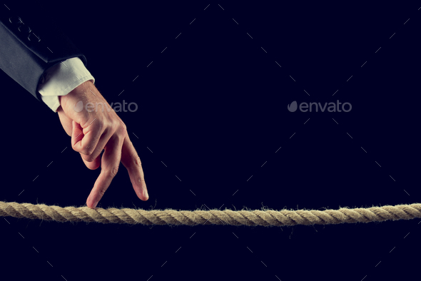 Fingers walking over frayed rope