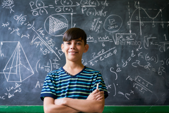 Confident Latino Boy Smiling At Camera During Math Lesson