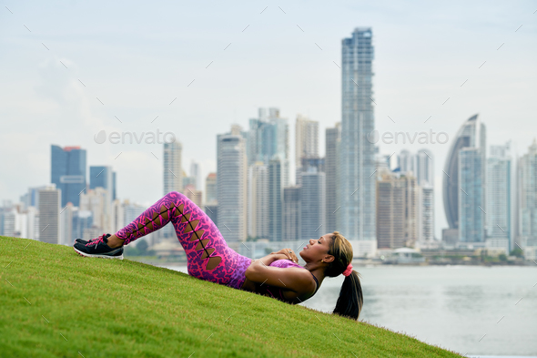 Woman Training ABS And Working Out In City Park - Stock Photo - Images