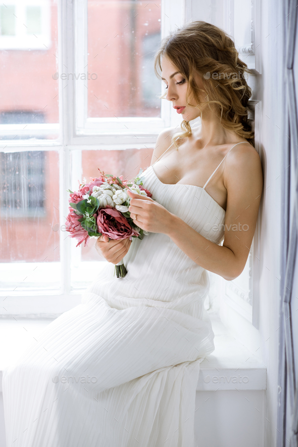 Brunette bride in fashion white wedding dress with makeup