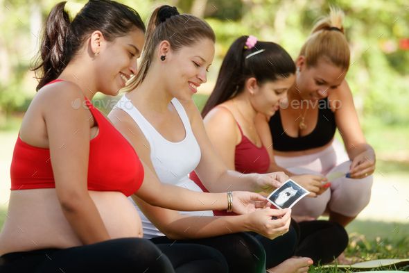 Pregnant Women Sharing Ecography Images In Prenatal Class - Stock Photo - Images