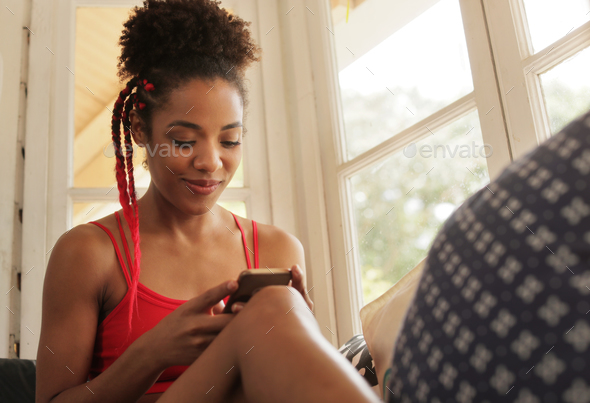 Young Black Woman Reading Phone Message And Smiling - Stock Photo - Images