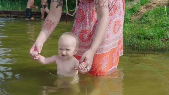 Mother Bathes the Baby in Pond alt