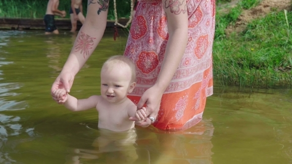 Mother Bathes the Baby in Pond