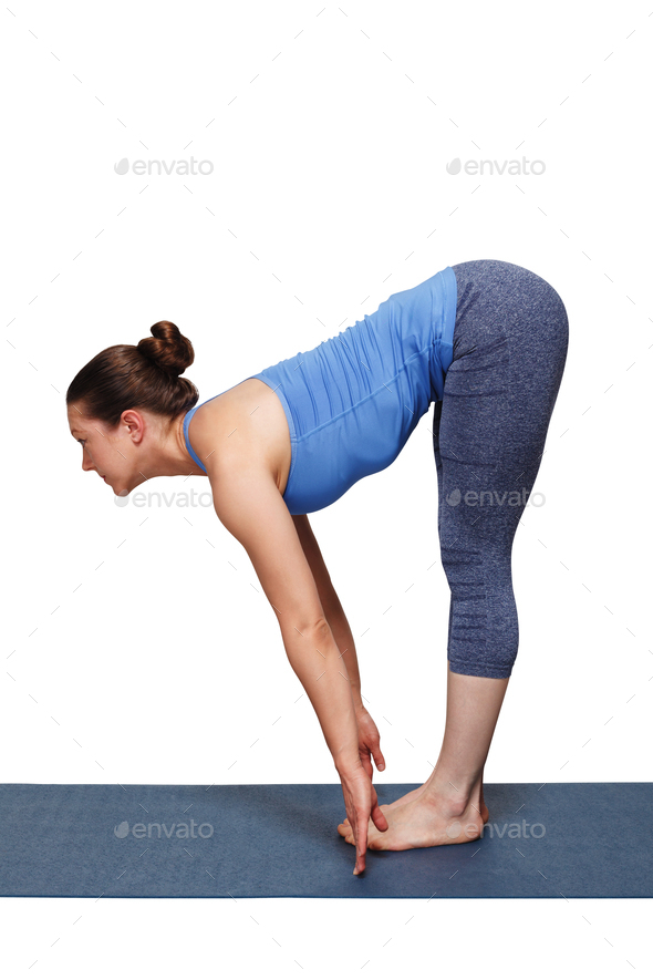 Woman doing yoga asana Uttanasana - standing forward bend