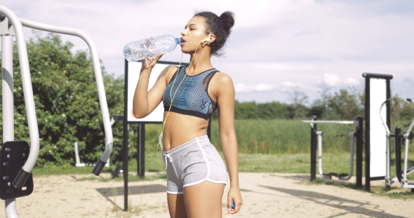 Sportive Girl Drinking at Workout alt