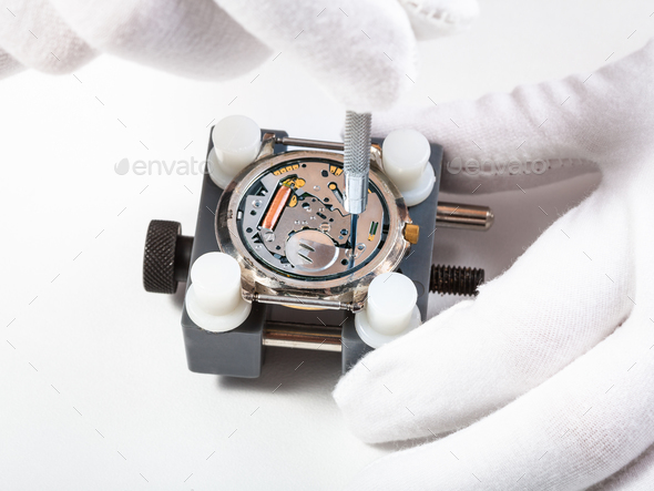 repairing quartz watch close up with screwdriver