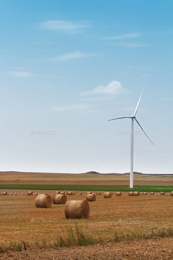 eolian wind turbine with wheat hay rolls