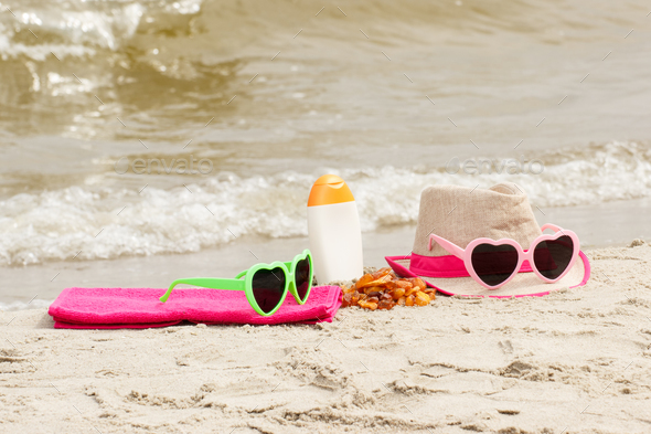 Accessories for vacation on sand at beach, concept of sun protection, summer time