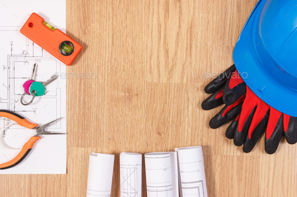 Home keys with electrical drawings, protective blue helmet with gloves and orange work tools - Stock Photo - Images