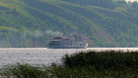 Cruise Ship Slowly Sailing on the River with a Steep Slope