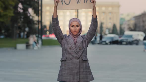 Young Serious Muslim Woman Islamic Girl in Hijab Female Activist Stands in City Street Protesting alt