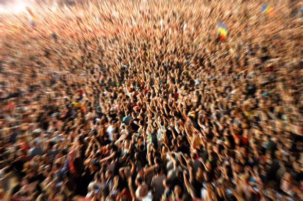 Zoom in effect on a blurred crowd partying at a music festival