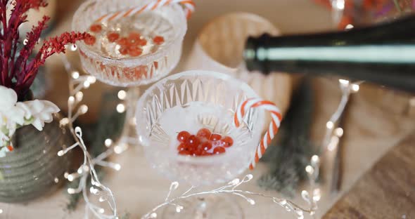 Pouring Sparkling Wine Into a Glass with Berries alt