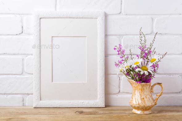 White frame mockup with chamomile and purple flowers in golden p