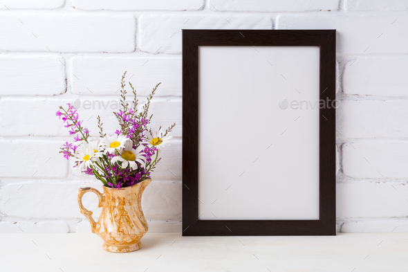 Black brown frame mockup with chamomile and purple flowers in g