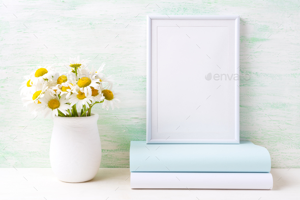 White frame mockup with chamomile bouquet in rustic vase and boo