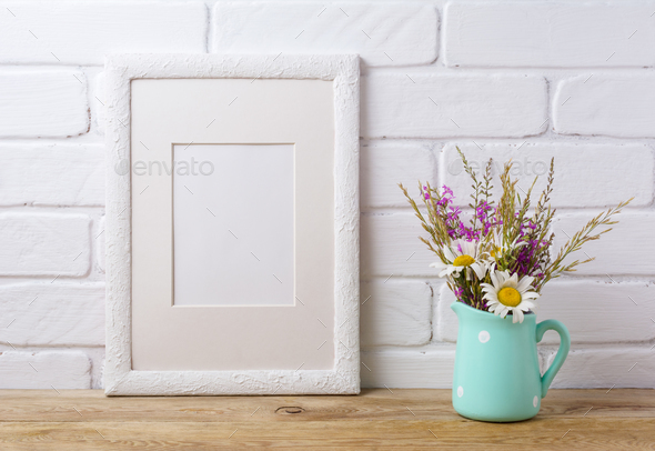 White frame mockup with chamomile and purple field flowers in mi