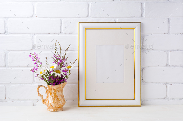 Gold decorated frame mockup with chamomile and purple flowers in