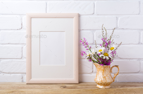 Wooden frame mockup with chamomile and purple flowers in golden