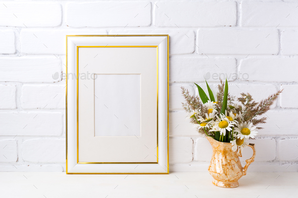 Gold decorated frame mockup with chamomile and grass in golden v