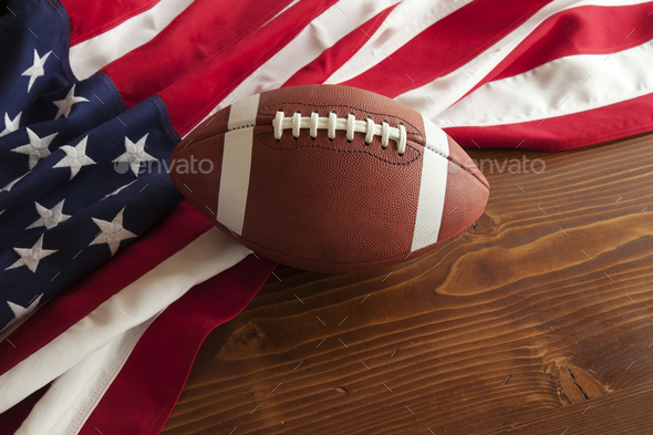 Football and American Flag on Wood Surface
