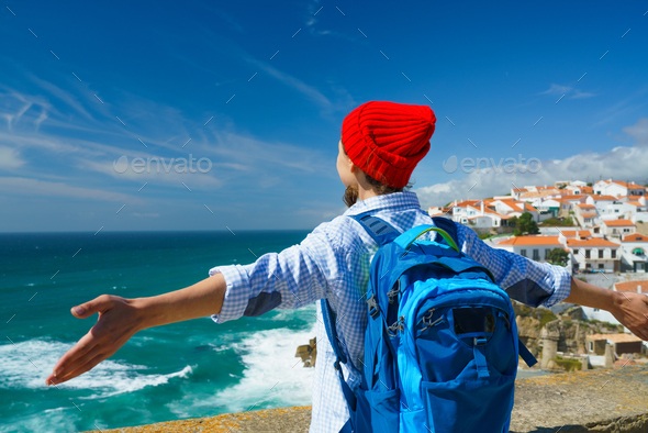 Woman with a backpack behind her back is spinning her arms out t - Stock Photo - Images