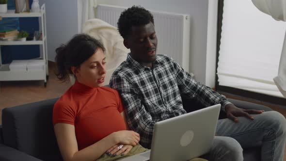 Young Interracial Couple Talking on Video Call Conference alt