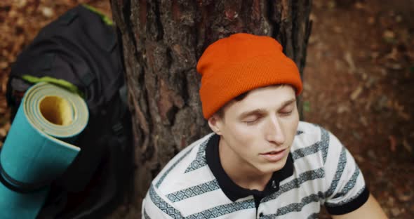 Relaxed Male Tourist Looking Up in Forest