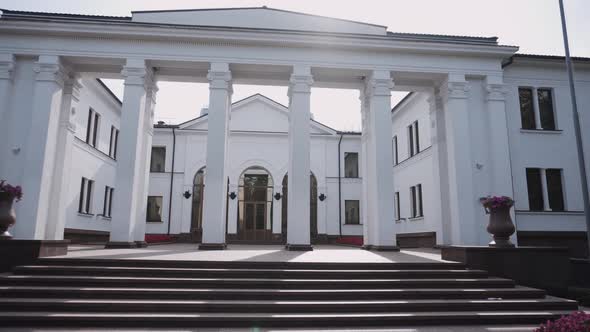 View of Facade of Rich White Palace with Columns Arches and Grand Staircase alt