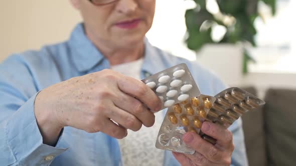 An Elderly Woman Chooses the Pill She Needs