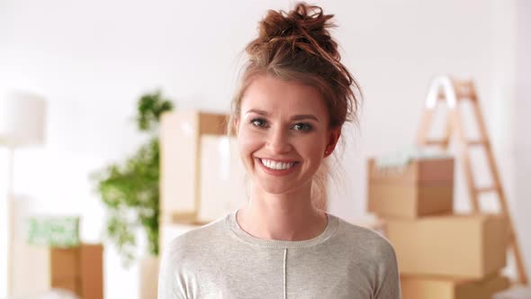 Portrait of smiling, young woman in her new apartment   alt