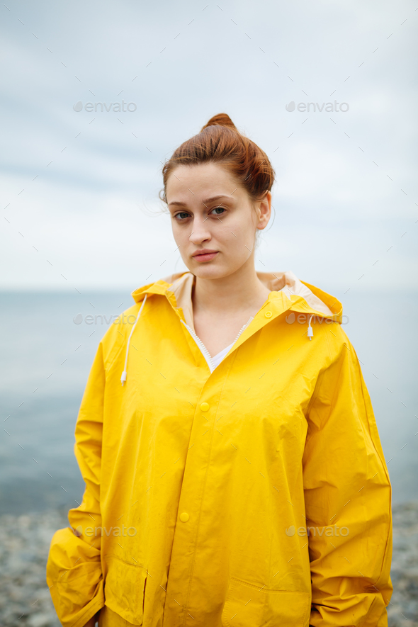 Girl wearing yellow raincoat