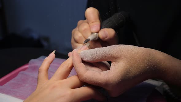 Anonymous Beautician Doing Manicure to Female Client