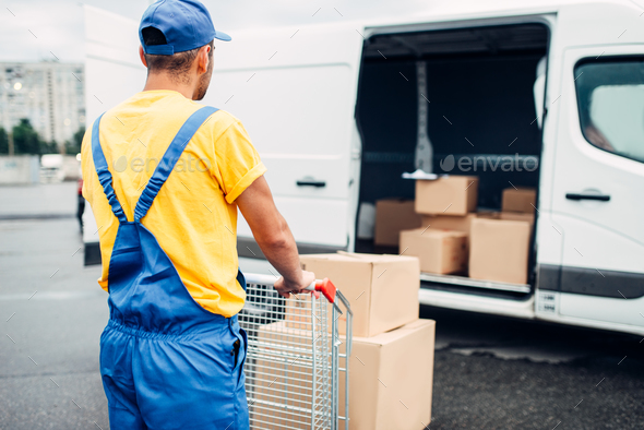 Male courier in uniform work with cargo, back view - Stock Photo - Images