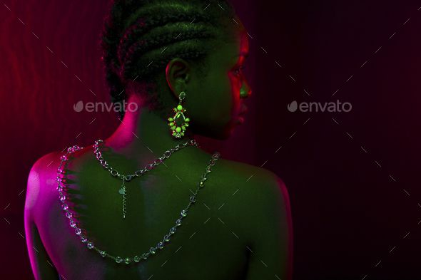 Colorful and creative portrait of african womans back with dark skin - Stock Photo - Images