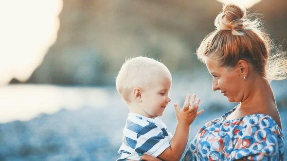 Happy Mother with Her Baby on the Beach alt