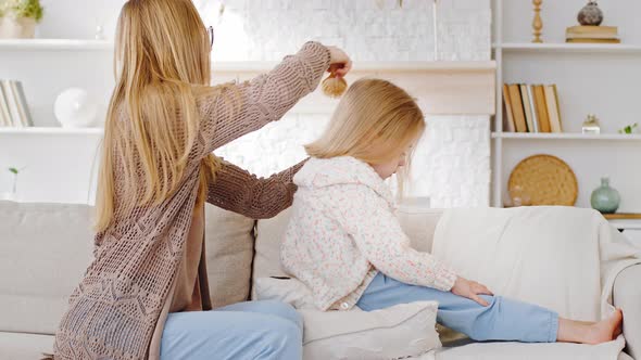 Young Family Caring Caucasian Mother Woman Babysitter Mommy Sits on Sofa with Daughter Little Child alt