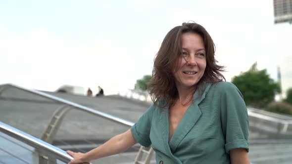 A Happy Adult Woman Walks Through a Modern City. A Little Madness of an Age Related Person alt