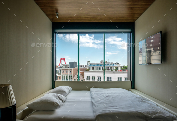 Hotel room with Rotterdam city cityscape skyline with Willemsbrug bridge in window