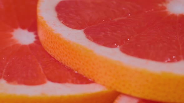 Fresh Citrus Fruit Red Slices of Grapefruit on Rotating Surface  Close Up