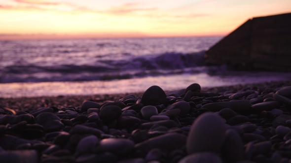 Smooth Pebble Stones on a Sea Shore at Dramatic Sunset. Shallow Depth of Field alt