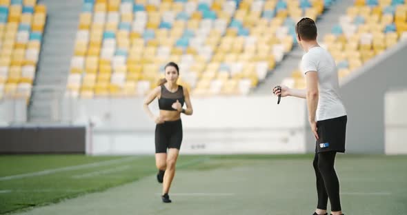 Female Jogger Finishing Race Record Trainer