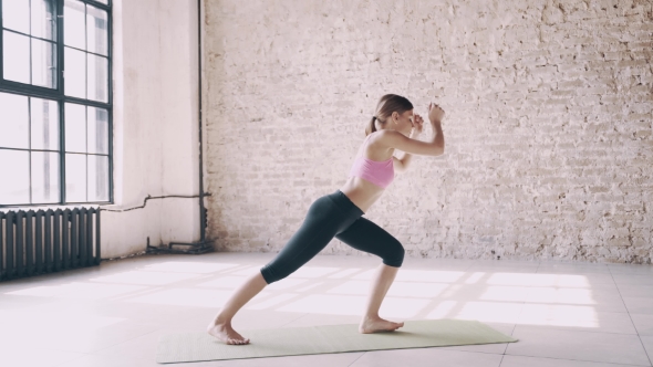 Beautiful Yoga Girl Doing Asanas in Studio