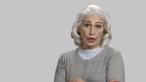 Old Lady Folding Her Arms and Scolding alt