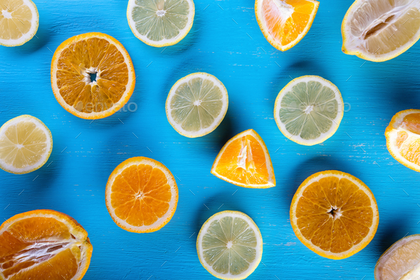 Blue background filled with sliced fruit - Stock Photo - Images