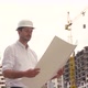 Architect or Engineer Working in Hard Hat Browsing Building Project of Construction Site with - VideoHive Item for Sale