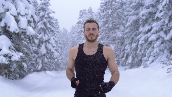 Strong man jogging in the snow. alt
